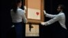 U.K. -- Sotheby's employees pose with the newly completed work by artist Banksy entitled "Love is in the Bin", a work that was created when the painting "Girl with Balloon" was passed through a shredder in a surprise intervention by the artist, at Sotheby