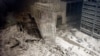 USA -- A group of firefighters walk amid rubble near the base of the destroyed south tower of the World Trade Center in New York on September 11, 2001. In