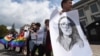 UKRAINE -- Activists of Ukrainian LGBT community hold a LGBT flag, signs reading " Stop Russian world" "stop hate" and pictures of Yelena Grigoryeva in front of the Russian embassy in Kyiv, July 24, 2019